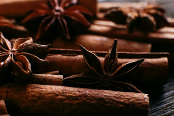 Spices sticks cinnamon and star anise on the old table. Rustic dark background, aroma close-up, macro.