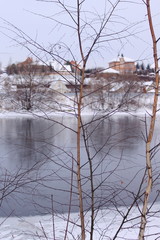 Winter view. Trees without leaves. Beautiful grey river 