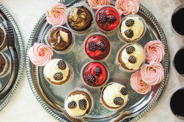 beautiful delicious cakes. confectionery curry at a festive party. many sweet muffins on a tray
