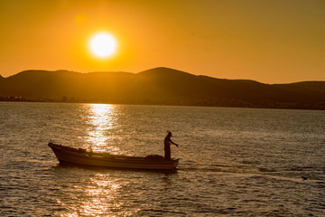 silhouette of fisherman at sunset