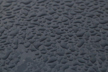 large drops on the surface of a gray car