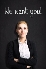 young businesswoman in front of blackboard with message 