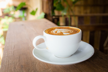hot cappuccino on the woodden table