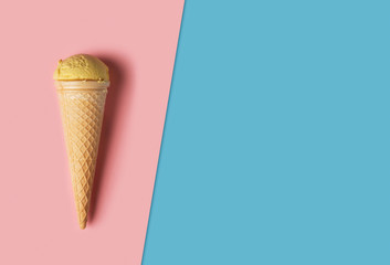 Ice cream with wafer cone on colored background