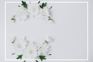 Creative flowers composition. Wreath made of white flowers on white background with frame. Spring and summer concept. Flat lay, copy space