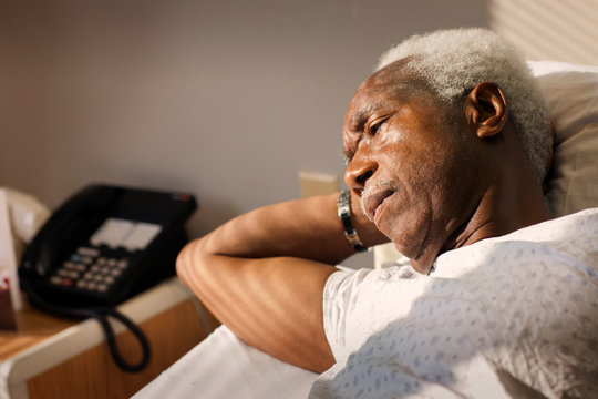Senior man lying in hospital bed 