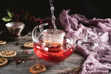 Hot red fruit tea in glass teapot