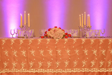 Wedding reception or fine dining table setup with embroidered organza tablecloth, crystal candle...