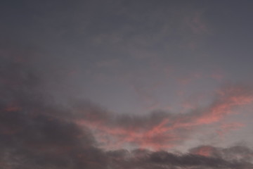 Evening sky during february with red purple violet sun light and clouds