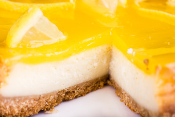Lemon cheesecake decorated with lemon zest close up. Selective focus