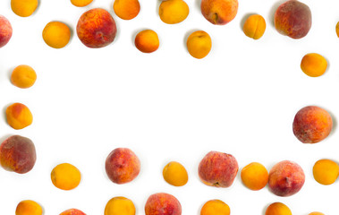 Frame of fresh orange apricots and peaches fruits on white background with space for text. Top view, flat lay