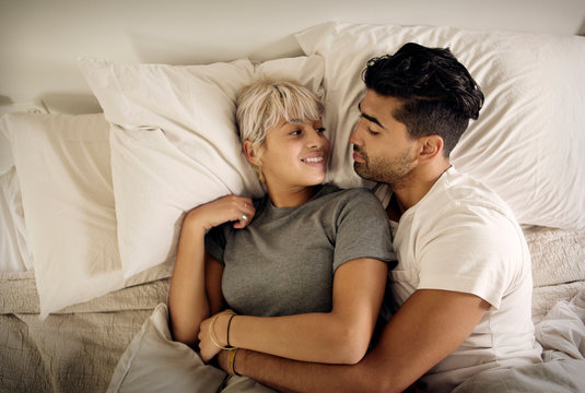Young couple lying in bed 
