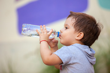 boy drinking water from a bottle