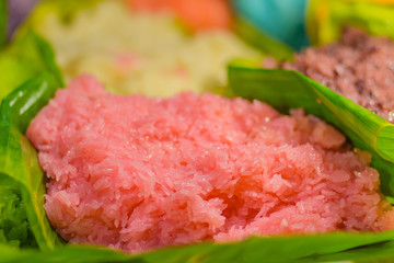 Colorful sticky rice in coconut milk for eat with ripe mango. Mango sticky rice is a traditional Thai dessert made with glutinous rice, fresh mango and coconut milk. Selective focus.
