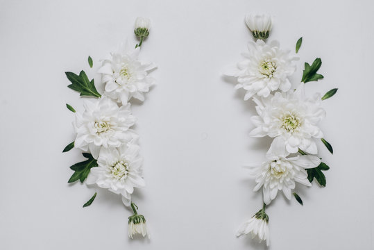 Flowers composition. Wreath made of white flowers on white background. Spring and summer concept. Flat lay, copy space