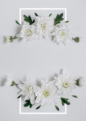 Creative flowers composition. Wreath made of white flowers on white background with frame. Spring and summer concept. Flat lay, copy space