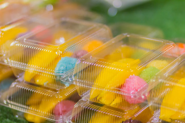 Colorful sticky rice in coconut milk for eat with ripe mango. Mango sticky rice is a traditional Thai dessert made with glutinous rice, fresh mango and coconut milk. Selective focus.