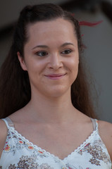 Half-length portrait of a girl with a viscose tank top with silver stitching. Frontal portrait of smiling fashion model looking in camera. Soap and water beauty concept.
