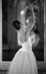Beautiful ballerina dancing in front of the mirror.