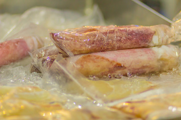 Fresh squid whole round on ice prepared for grilling. Close up fresh squid on ice in trays fresh market zone at the supermarket for sale.