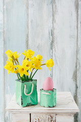 Daffodil flowers in ceramic vase. Easter table decoration
