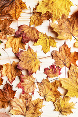 Autumn leaves on wooden background.
