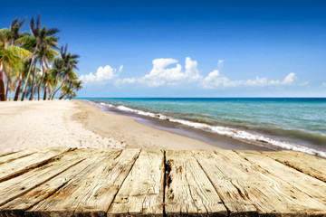 Fototapeta premium Wooden desk of free space and summer time on beach. 