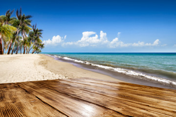 Fototapeta premium Wooden desk of free space and summer time on beach. 