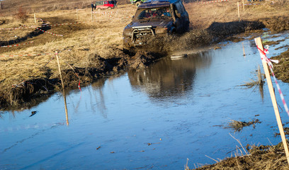 Obraz premium Ukrainian offroad competition in the city of Kamyanets Podilsky. Swamp and mud on cars. Produce large puddles
