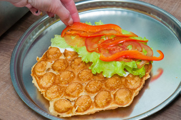 Bubble waffle, сooking waffles with tomatoes, lettuce, cheese