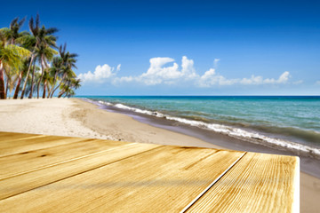 Fototapeta premium Wooden desk of free space and summer time on beach. 