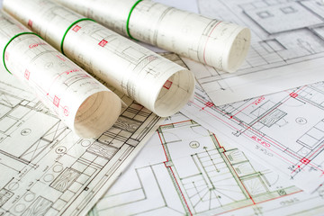 Architect workplace. Architectural project, blueprints, blueprint rolls on wooden desk table. Construction background. Engineering tools. Copy space