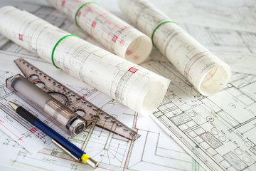 Architect workplace. Architectural project, blueprints, blueprint rolls on wooden desk table. Construction background. Engineering tools. Copy space