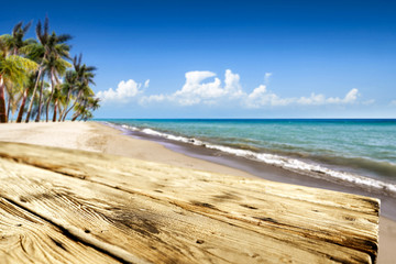 Wooden desk of free space and summer time on beach. 