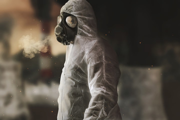 survivor with white overall and gas mask in front of blurred incineration plant and apocalyptic...