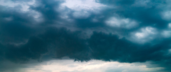 Panorama of the sky during a thunderstorm. Dark dramatic stormy sky.