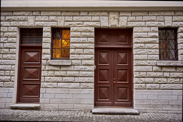 Old doors and windows on brick wall.