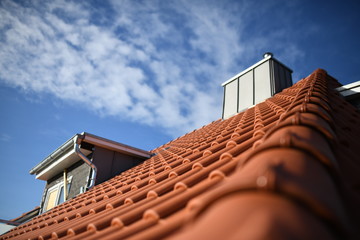 Haus Dach mit roter Bedachung aus Dachziegeln. Dachgaube mit Fenster Bau und Schornstein im...