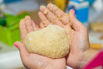 Kneading the dough. Woman's hands. Cooking. Master class. Cooking of the dough. Manicure. Knead dough. Apron. Dough in hand.