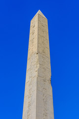 Granite obelisk against blue sky in a Karnak temple. Luxor, Egypt.