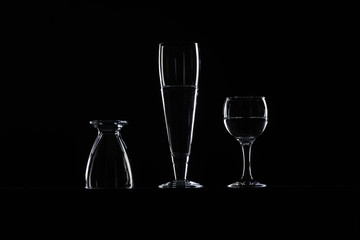 set of transparent glasses on black background 