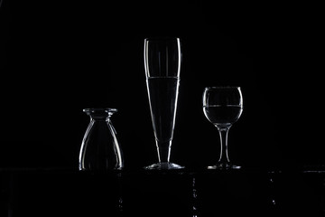 three glasses of water on a black background