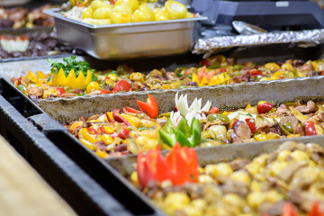 Traditional Hungarian pig slaughter dishes. Street food festival, food service. Fried pork with vegetables