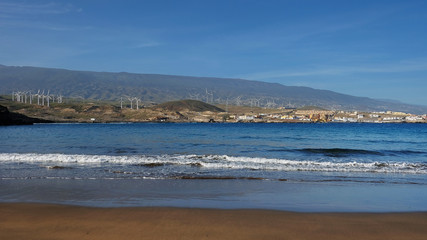 Empty and clean beautiful beach with inland views of the south-eastern coast of the island, at Playa Poris de Abona, Tenerife, Canary Islands, Spain