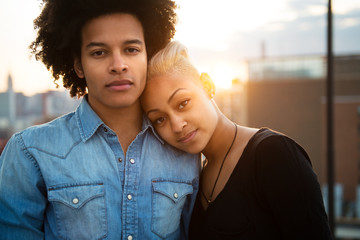 Portrait of young couple standing outdoors