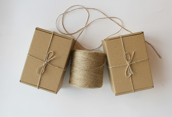 cardboard gift boxes on a white background a hank of rope