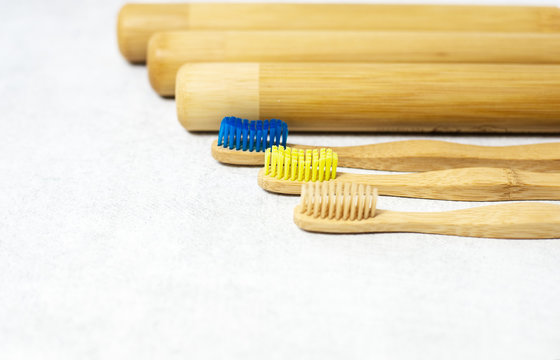 A family set of wooden bamboo toothbrushes on white background