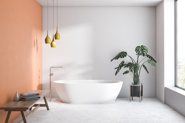 White and orange bathroom with white tub