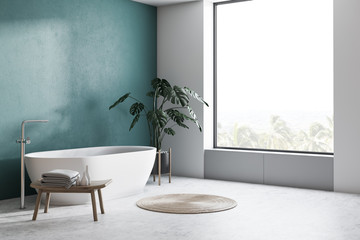 Green and white bathroom corner with tub