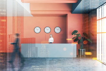People in interior of orange office with reception